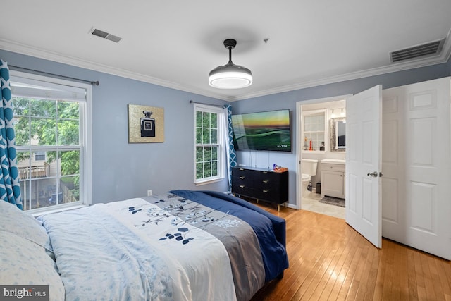 1712 Apple Blossom Ct, Bowie, MD 20721 - bedroom with light wood-type flooring, crown molding, multiple windows, and connected bathroom