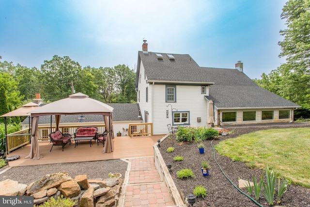 175 Pullen Station Rd, Quakertown, PA 18951 - rear view of house featuring a gazebo, a chimney, a wooden deck, an outdoor hangout area, and roof with shingles