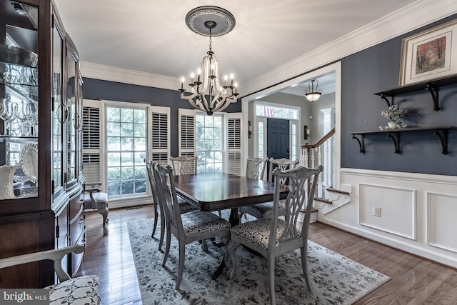 12655 Arthur Graves Jr Ct, Bristow, VA 20136 - dining room featuring a chandelier, ornamental molding, a wainscoted wall, wood finished floors, and a decorative wall