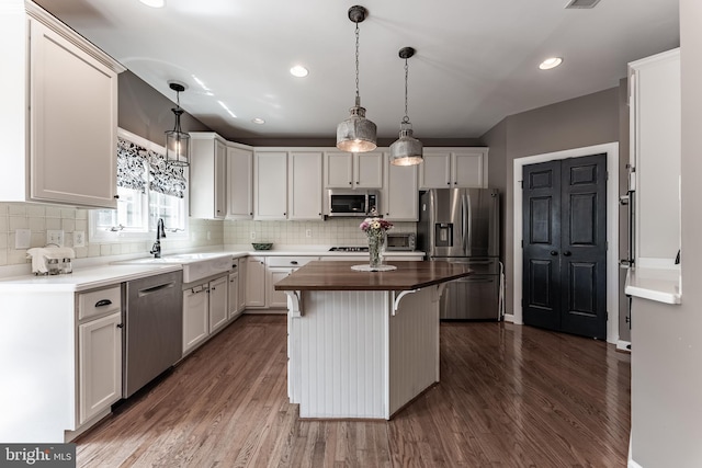 12655 Arthur Graves Jr Ct, Bristow, VA 20136 - kitchen featuring stainless steel appliances, butcher block counters, dark wood finished floors, decorative backsplash, and recessed lighting