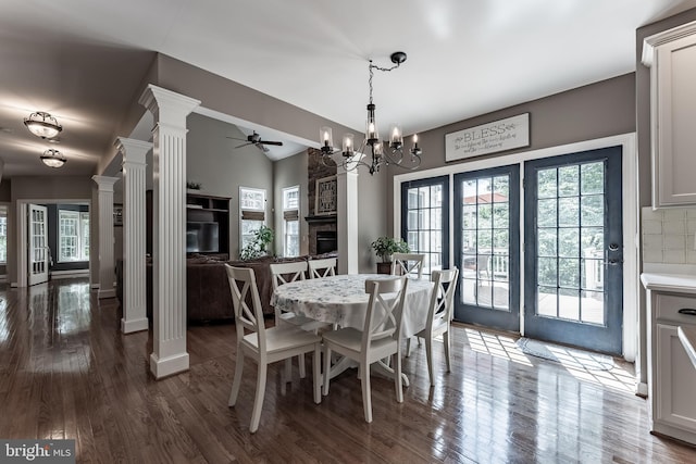 12655 Arthur Graves Jr Ct, Bristow, VA 20136 - dining space featuring decorative columns, a ceiling fan, a stone fireplace, plenty of natural light, and lofted ceiling
