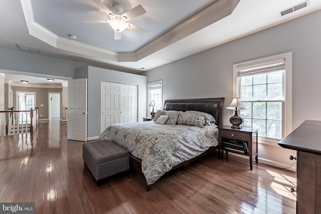 12655 Arthur Graves Jr Ct, Bristow, VA 20136 - bedroom featuring a raised ceiling, crown molding, dark wood-style floors, a closet, and ceiling fan