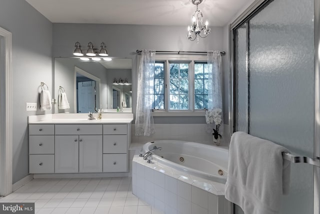 12655 Arthur Graves Jr Ct, Bristow, VA 20136 - bathroom featuring a tub with jets, tile patterned floors, vanity, and a chandelier