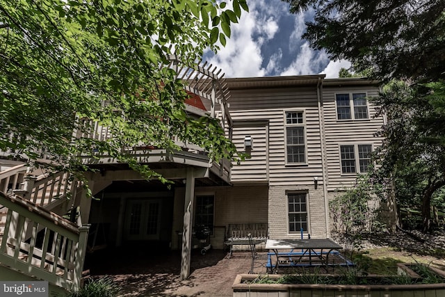 12655 Arthur Graves Jr Ct, Bristow, VA 20136 - back of property with french doors, a deck, a patio area, and brick siding