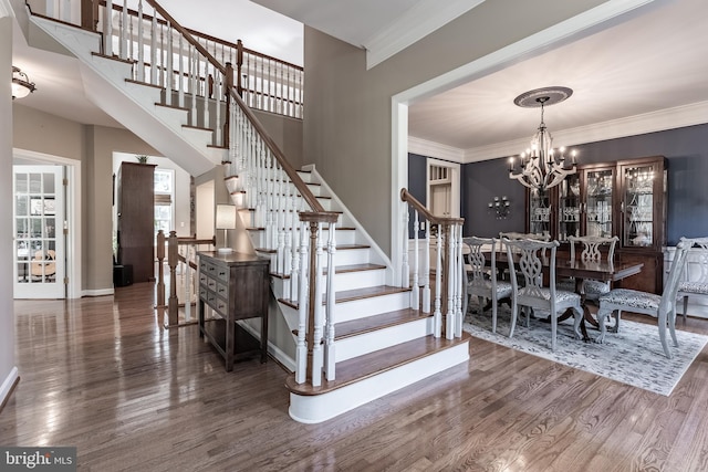 12655 Arthur Graves Jr Ct, Bristow, VA 20136 - dining space featuring wood finished floors, stairway, a chandelier, and ornamental molding