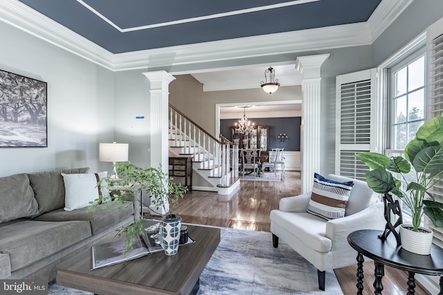 12655 Arthur Graves Jr Ct, Bristow, VA 20136 - living room with ornate columns, stairway, a chandelier, wood finished floors, and ornamental molding
