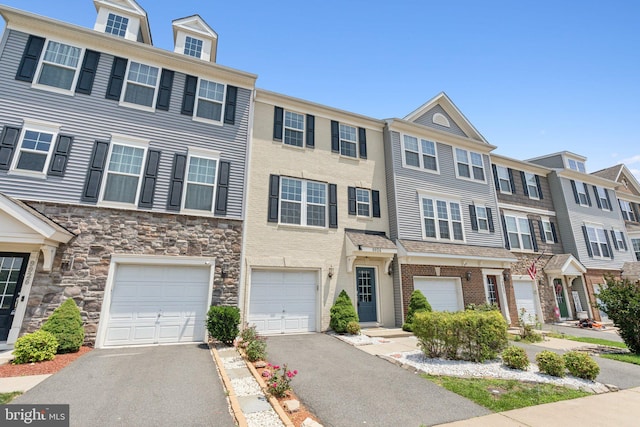 9924 Whitemoss Dr, Manassas, VA 20109 - townhome / multi-family property featuring driveway, an attached garage, a residential view, and stone siding