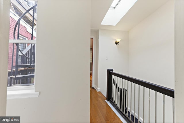 3016 Dillon St, Baltimore, MD 21224 - hallway with a skylight, an upstairs landing, and hardwood / wood-style flooring
