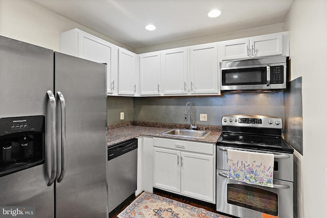 3016 Dillon St, Baltimore, MD 21224 - kitchen featuring appliances with stainless steel finishes, white cabinetry, dark countertops, and recessed lighting