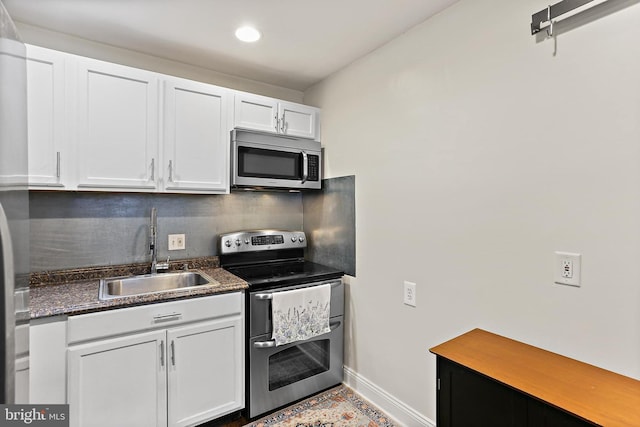 3016 Dillon St, Baltimore, MD 21224 - kitchen featuring stainless steel appliances, white cabinets, recessed lighting, and backsplash