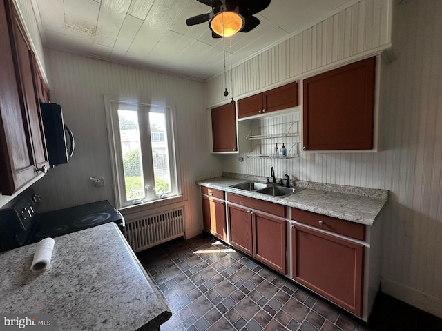 2326 Franklin Ave, Morton, PA 19070 - kitchen with radiator heating unit, black appliances, a ceiling fan, light countertops, and stone finish floors