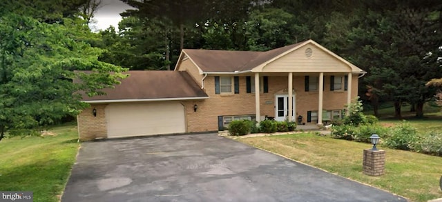10813 Wilcox Dr, Williamsport, MD 21795 - split foyer home with asphalt driveway, a garage, a front lawn, and brick siding