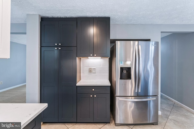 1240 Windmill Ln, Silver Spring, MD 20905 - kitchen featuring stainless steel refrigerator with ice dispenser, a textured ceiling, tasteful backsplash, light tile patterned floors, and gray cabinetry