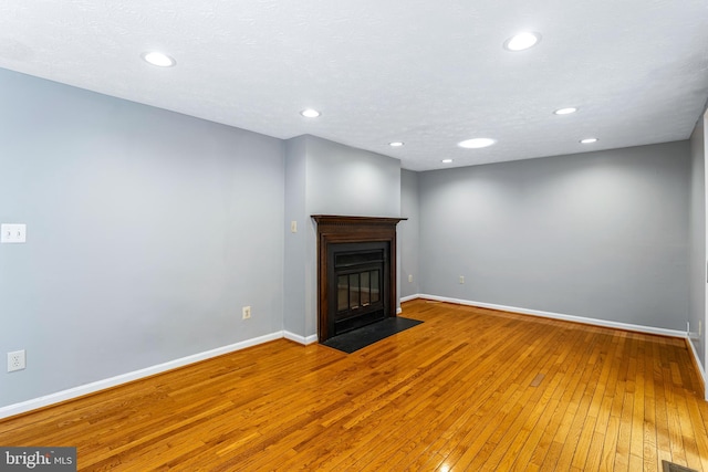 1240 Windmill Ln, Silver Spring, MD 20905 - unfurnished living room with hardwood / wood-style flooring, recessed lighting, and a fireplace with flush hearth