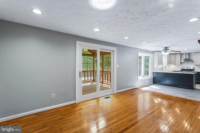 1240 Windmill Ln, Silver Spring, MD 20905 - unfurnished living room with light wood-style flooring, ceiling fan, and recessed lighting