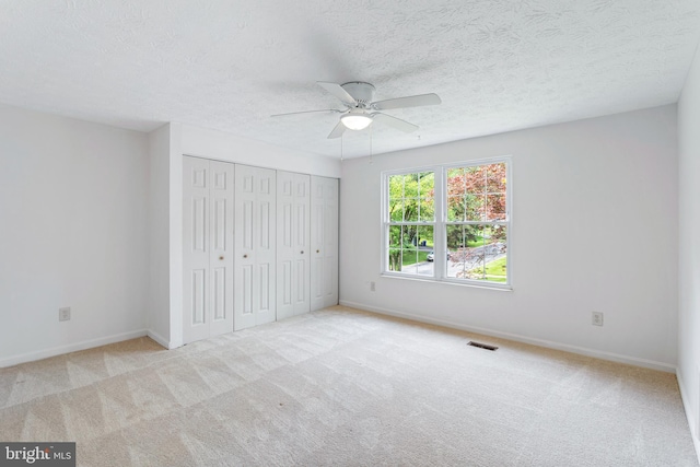 1240 Windmill Ln, Silver Spring, MD 20905 - unfurnished bedroom with carpet floors, a closet, a textured ceiling, and a ceiling fan