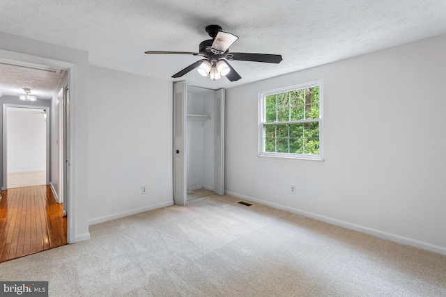 1240 Windmill Ln, Silver Spring, MD 20905 - unfurnished bedroom featuring carpet flooring, a textured ceiling, a closet, a ceiling fan, and attic access