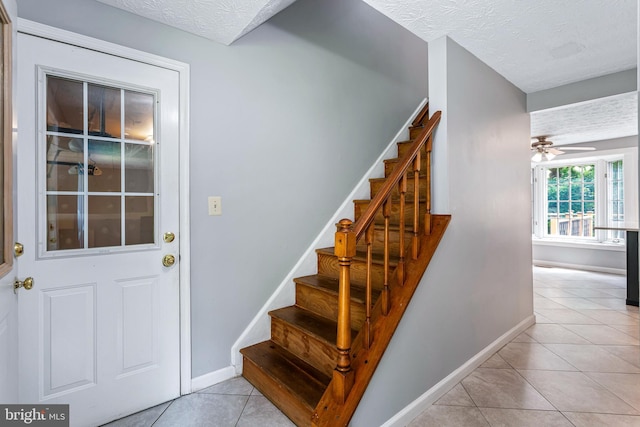 1240 Windmill Ln, Silver Spring, MD 20905 - stairway featuring tile patterned floors, a textured ceiling, and ceiling fan