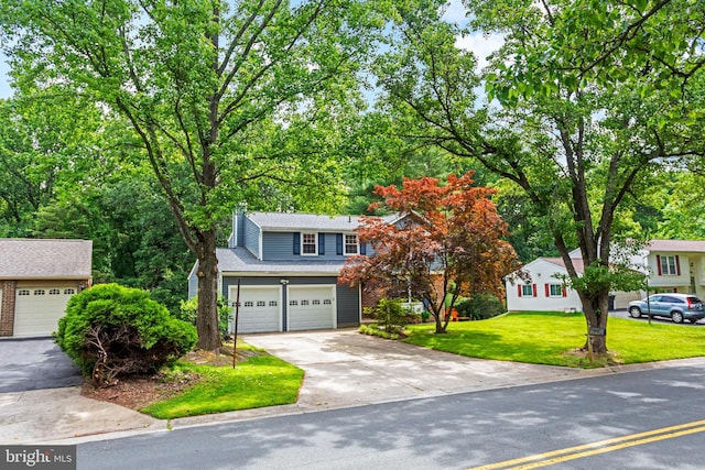 1240 Windmill Ln, Silver Spring, MD 20905 - view of front facade featuring concrete driveway, a front lawn, a garage, and a chimney