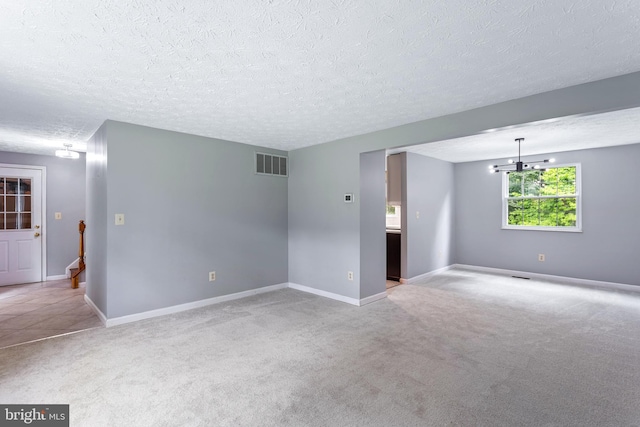 1240 Windmill Ln, Silver Spring, MD 20905 - spare room with a textured ceiling, light colored carpet, and a chandelier