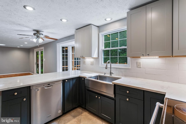1240 Windmill Ln, Silver Spring, MD 20905 - kitchen with dishwasher, a peninsula, ceiling fan, backsplash, and light stone counters
