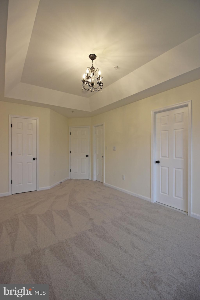 3655 Islington St, Frederick, MD 21704 - spare room featuring a raised ceiling, a chandelier, light carpet, and baseboards