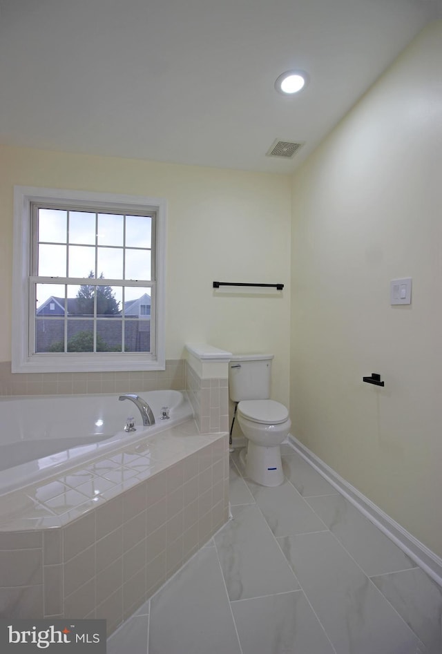 3655 Islington St, Frederick, MD 21704 - full bathroom with a garden tub and marble look tile flooring