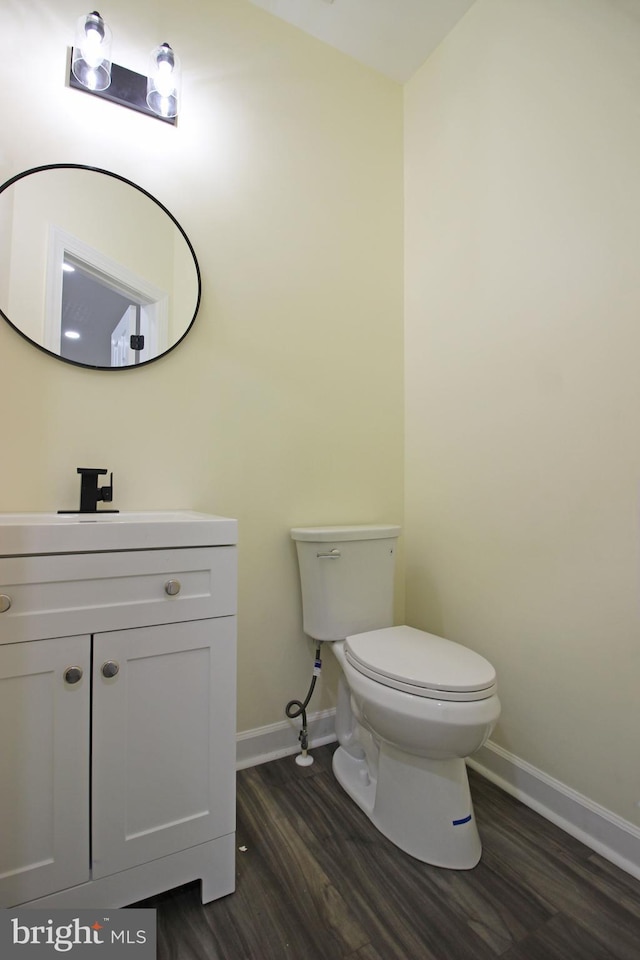 3655 Islington St, Frederick, MD 21704 - half bath with baseboards, wood finished floors, toilet, and vanity