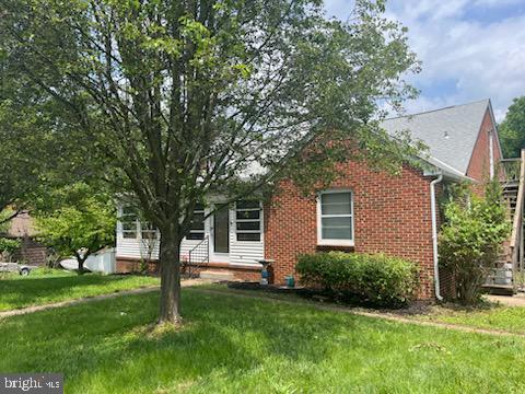 932 Mount Aetna Rd, Hagerstown, MD 21740 - view of property hidden behind natural elements featuring a front yard and brick siding