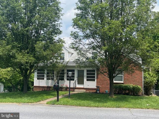 932 Mount Aetna Rd, Hagerstown, MD 21740 - view of property hidden behind natural elements featuring a front lawn and brick siding