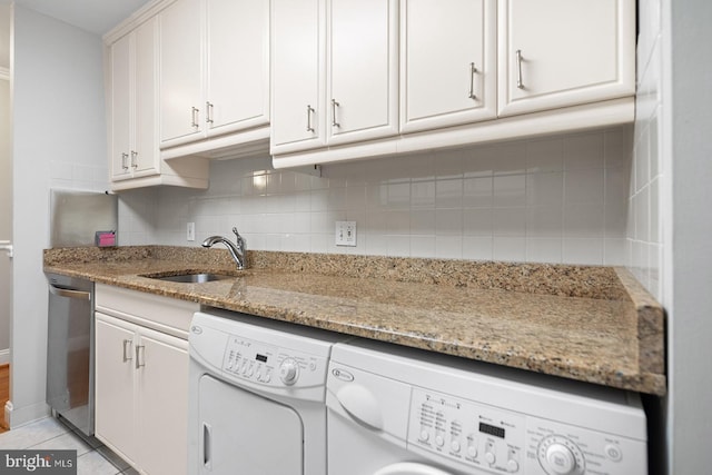 1901 John F Kennedy Blvd Unit 1414, Philadelphia, PA 19103 - kitchen featuring separate washer and dryer, stainless steel dishwasher, tasteful backsplash, white cabinets, and light stone countertops