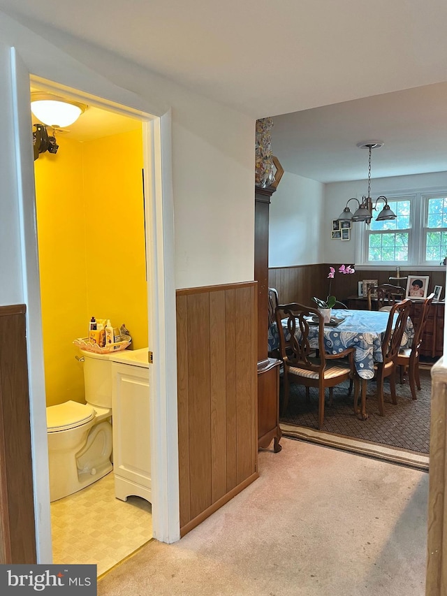 9013 Ashton Rd, Philadelphia, PA 19136 - carpeted dining area featuring a wainscoted wall, a chandelier, and wood walls