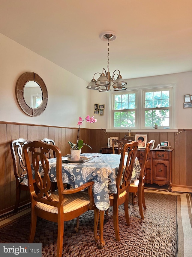 9013 Ashton Rd, Philadelphia, PA 19136 - dining room with a chandelier, wainscoting, wood walls, and carpet