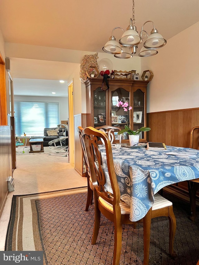 9013 Ashton Rd, Philadelphia, PA 19136 - carpeted dining area with a wainscoted wall, a chandelier, and wood walls