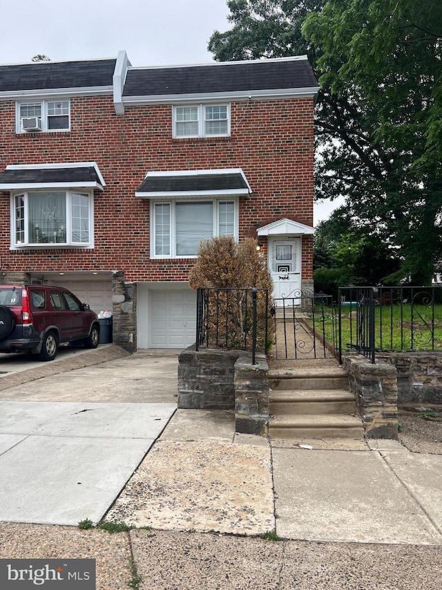 9013 Ashton Rd, Philadelphia, PA 19136 - view of property with concrete driveway, an attached garage, brick siding, and stone siding