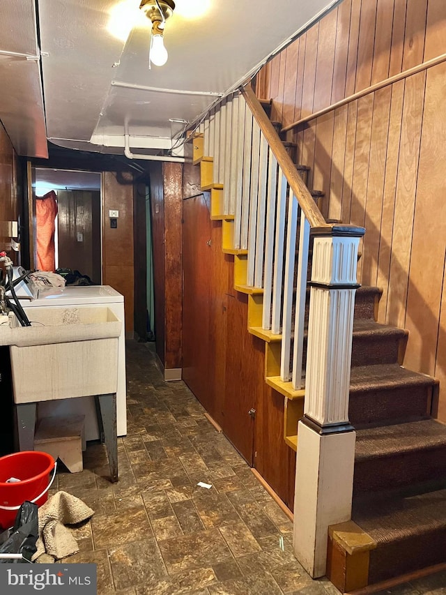 9013 Ashton Rd, Philadelphia, PA 19136 - stairs featuring wooden walls, stone finish flooring, and washer and clothes dryer