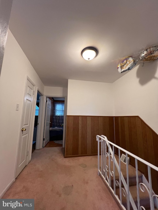 9013 Ashton Rd, Philadelphia, PA 19136 - hallway with wainscoting, wood walls, and light carpet