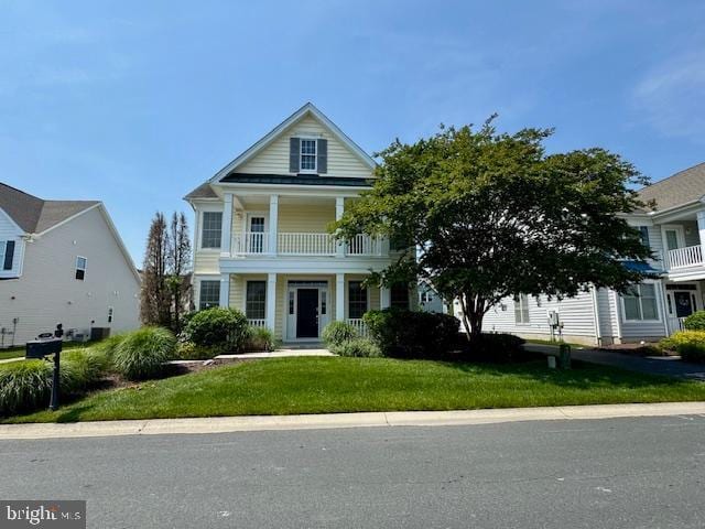 12410 Coastal Marsh Dr, Berlin, MD 21811 - view of front facade with a balcony and a front lawn