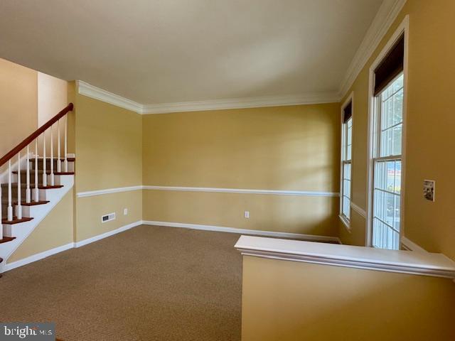 12410 Coastal Marsh Dr, Berlin, MD 21811 - empty room featuring stairway, ornamental molding, and carpet