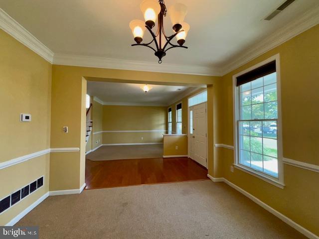 12410 Coastal Marsh Dr, Berlin, MD 21811 - carpeted empty room featuring a chandelier and crown molding
