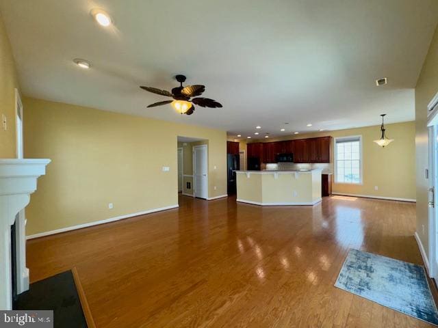 12410 Coastal Marsh Dr, Berlin, MD 21811 - unfurnished living room featuring dark wood-type flooring, a fireplace with flush hearth, ceiling fan, and recessed lighting