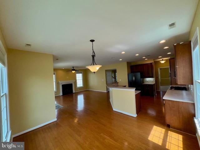 12410 Coastal Marsh Dr, Berlin, MD 21811 - kitchen featuring freestanding refrigerator, open floor plan, dark wood-type flooring, ceiling fan, and hanging light fixtures