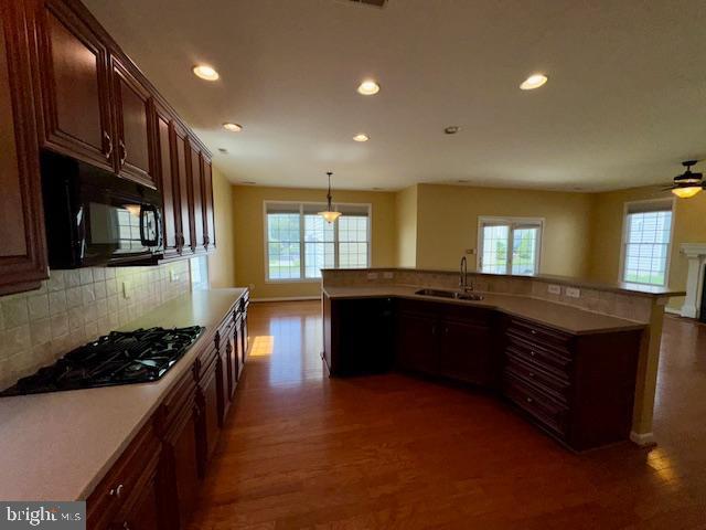 12410 Coastal Marsh Dr, Berlin, MD 21811 - kitchen with black microwave, gas cooktop, healthy amount of natural light, wood finished floors, and recessed lighting