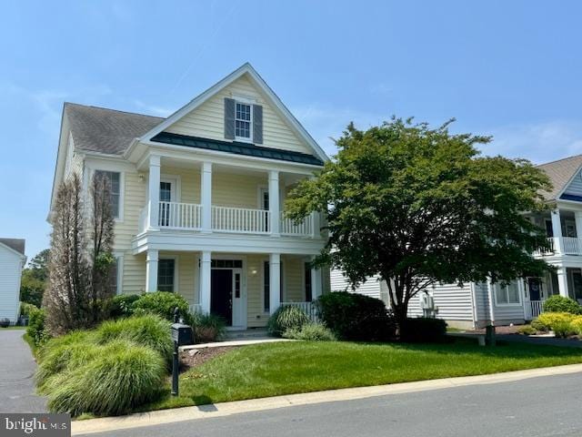12410 Coastal Marsh Dr, Berlin, MD 21811 - greek revival house with a porch, a standing seam roof, a balcony, a metal roof, and a front yard