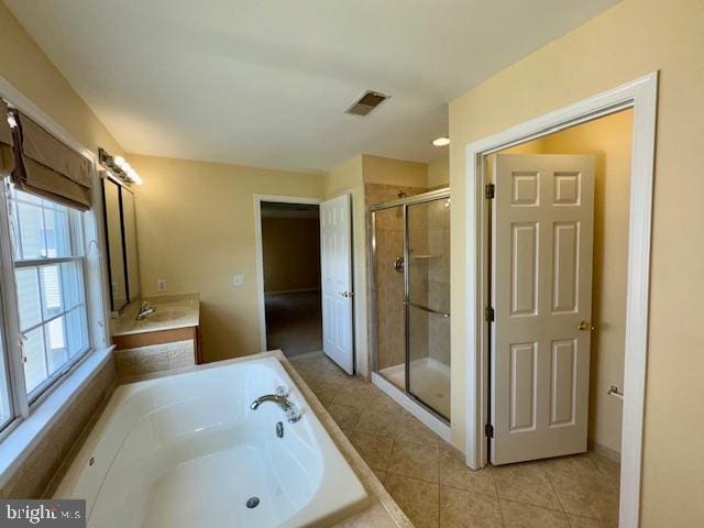 12410 Coastal Marsh Dr, Berlin, MD 21811 - full bath featuring a shower stall, a garden tub, vanity, and tile patterned floors