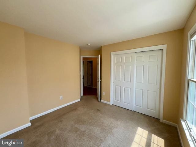 12410 Coastal Marsh Dr, Berlin, MD 21811 - unfurnished bedroom with carpet floors, a closet, and multiple windows