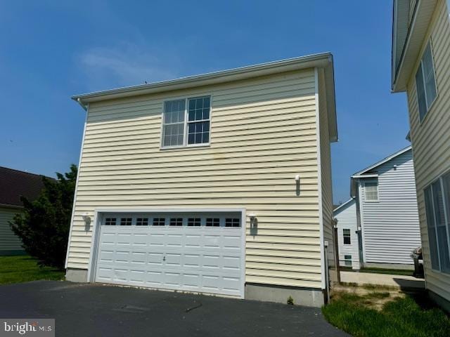 12410 Coastal Marsh Dr, Berlin, MD 21811 - view of side of property with asphalt driveway and a garage