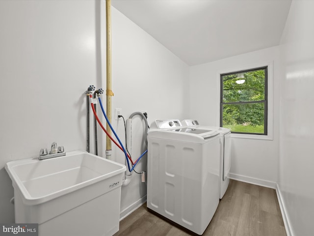 9124 Goldamber Garth, Columbia, MD 21045 - washroom with light wood-type flooring and independent washer and dryer
