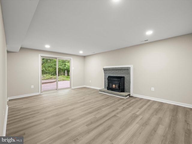 9124 Goldamber Garth, Columbia, MD 21045 - unfurnished living room with light wood-style flooring, recessed lighting, and a fireplace