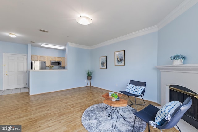1581 Spring Gate Dr Unit 5309, Mclean, VA 22102 - sitting room with crown molding, light wood-style flooring, and a fireplace